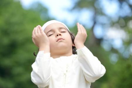 little-arabic-boy-praying-outdoor-in-nature