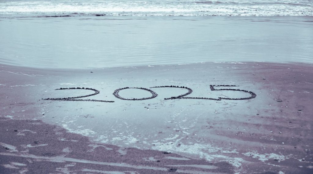 hand write 2024 2025 on sea beach