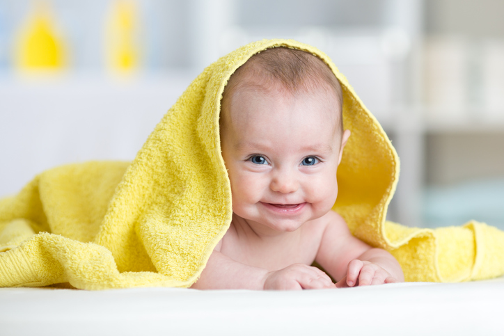Cute smiling baby after shower or bathing