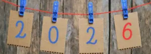 FB cover photo figures for 2026 are hung on cardboard cards hung on clothespins on a white background photo