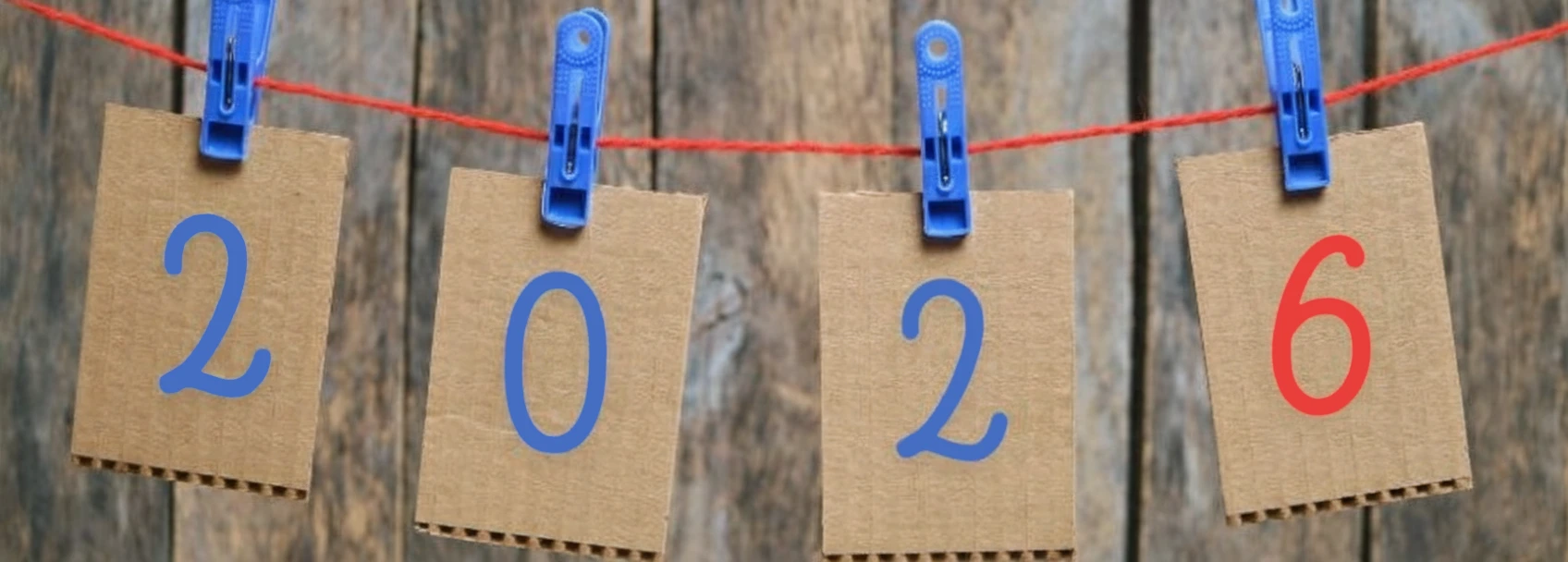 FB cover photo figures for 2026 are hung on cardboard cards hung on clothespins on a white background photo