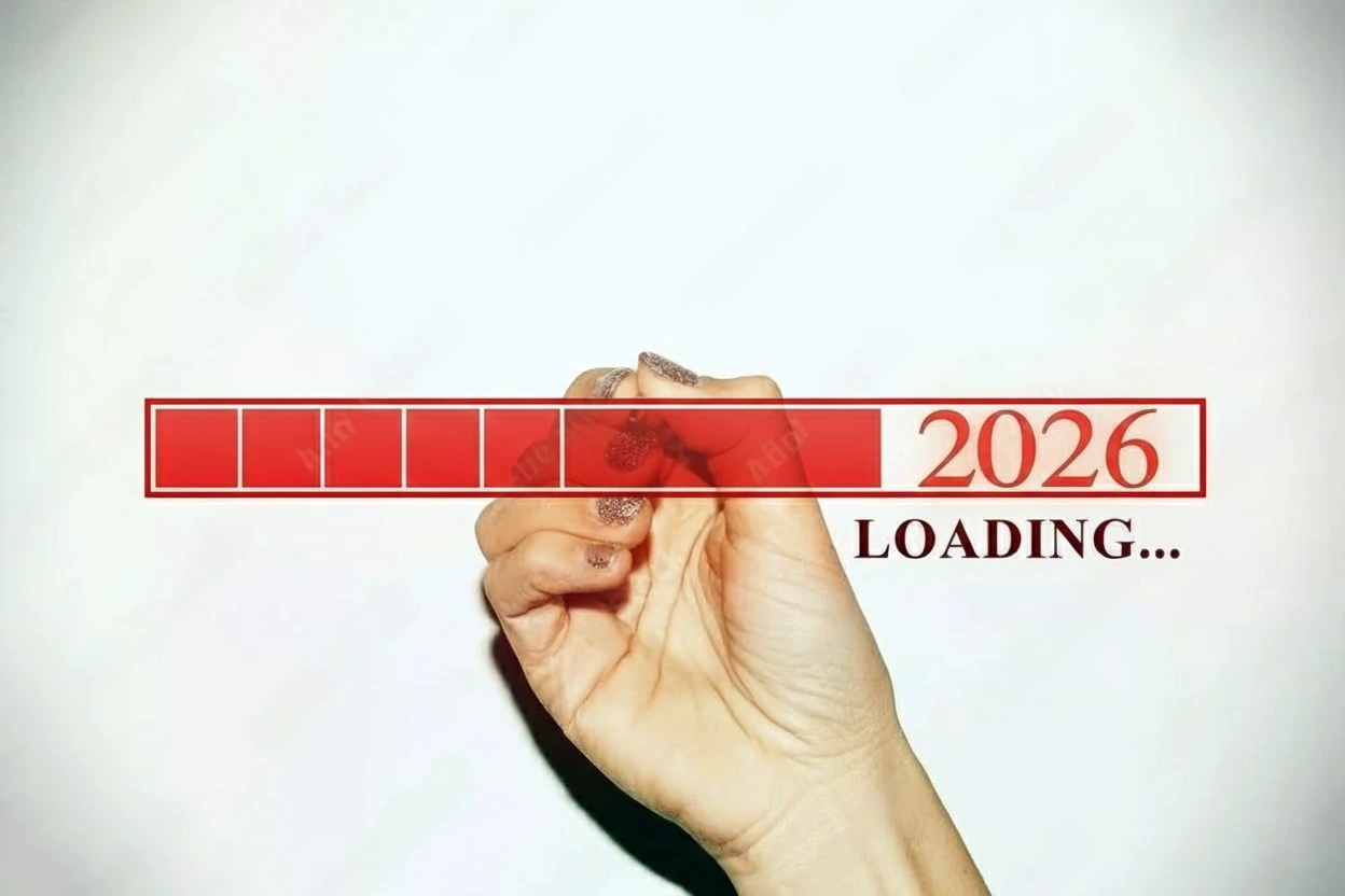Woman hand with glitter nails showing the Loading Bar with the year 2026 Woman hand with glitter nails showing the Loading Bar with the year 2026
