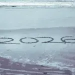 hand write 2026 on sea beach with 2026 written in the sand hand write 2026 on sea beach with 2026 written in the sand