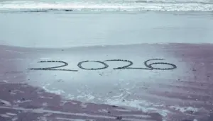 hand write 2026 on sea beach with 2026 written in the sand hand write 2026 on sea beach with 2026 written in the sand