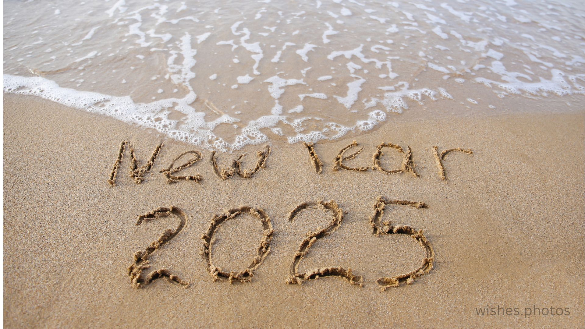 The inscription 2025 on the sand by the sea. Happy New Year. wishes.photos